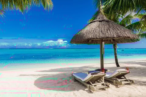 Luxury tropical beach with umbrella and chairs