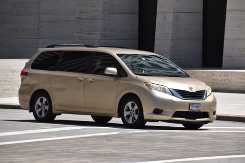 Gold Toyota Sienna minivan for family rental